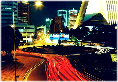 Kuala Lumpur, Malaysia, at night. Showing streaks of car tail lights.