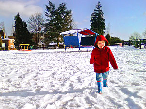child playing in the snow